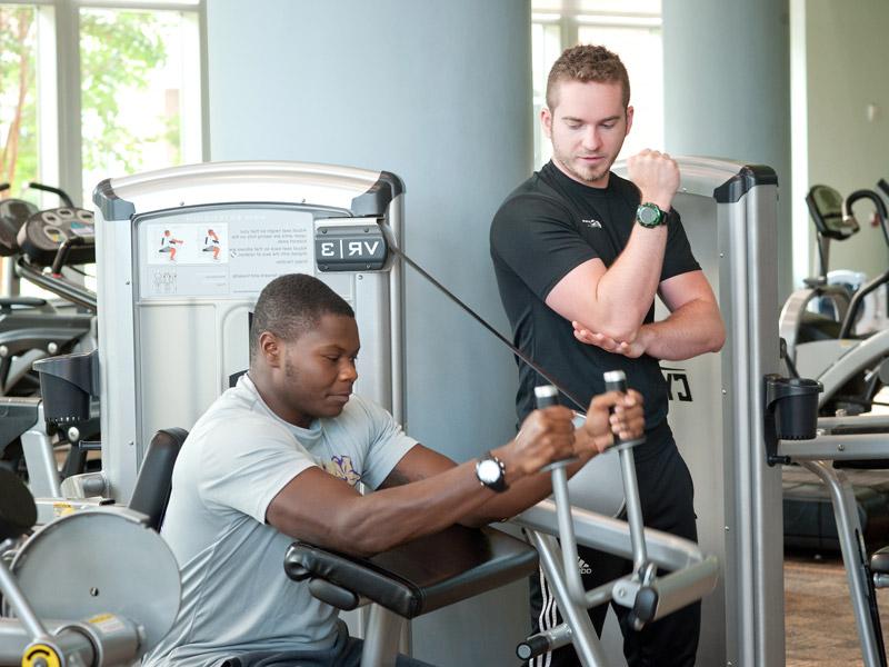 two men working with exercise equipment